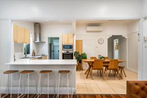 a kitchen and dining room with a table and chairs at Wattleseed - 4 Wattle Street in Evans Head
