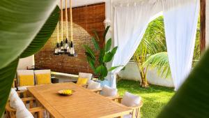 a wooden table and chairs in a room with a patio at Villa Agata Mauritius in Mont Choisy