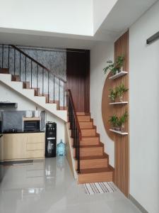 a staircase in a house with potted plants at Shania home in Bogor