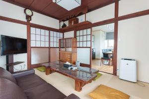 a living room with a couch and a table at WTN Way too nice in Fujikawaguchiko