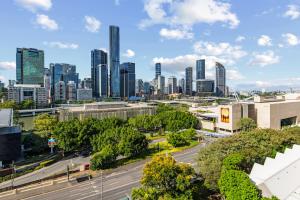 a city skyline with a road and buildings at Brisbane Skyline View 2Beds River view Apt in Brisbane