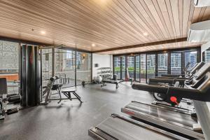 a gym with treadmills and machines in a building at Brisbane Skyline View 2Beds River view Apt in Brisbane