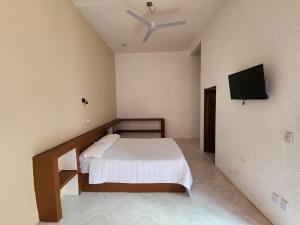 a bedroom with a bed and a flat screen tv at Hotel Don Candido in Tuxtla Gutiérrez