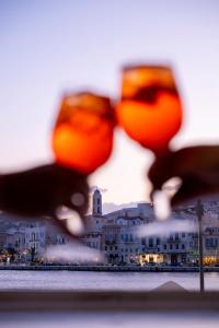 a group of wine glasses with a view of a city at Hotel Aktaion Syros in Ermoupoli