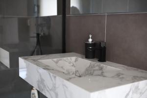 a bathroom with a marble counter with a soap dispenser at Airport bari grey in Bari