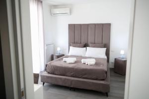 a bedroom with a large bed with two pillows on it at Airport bari grey in Bari