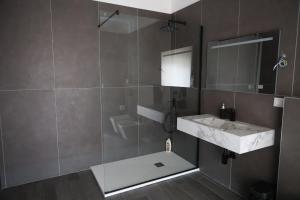 a bathroom with a sink and a mirror at Airport bari grey in Bari