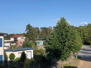 an aerial view of a residential neighbourhood with a tree at Panorama Suite in Lubmin