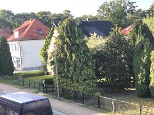 a van parked on a street next to a house at Panorama Suite in Lubmin