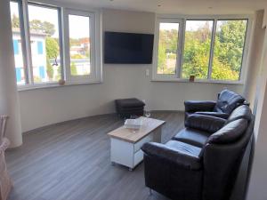 a living room with a couch and a table at Panorama Suite in Lubmin