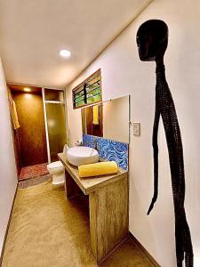 a bathroom with a black person on the wall at Beachfront Bungalows Bucana, El Nido in El Nido