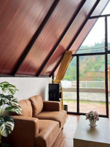 a living room with a couch and a large window at Heavenly 1 - Private Triangle in Bandung