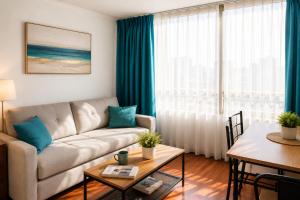a living room with a couch and a table at Departamentos Amoblados Torre Tagle in Santiago +28 photos
