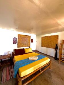 a bedroom with a large bed in a room at Beachfront Bungalows Bucana, El Nido in El Nido