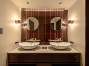a bathroom with two sinks and two mirrors at illi Tex Aoyama in Tokyo +32 photos
