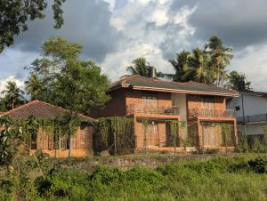 an old house with a fence in front of it at Hotel Villa Lake View in Kurunegala
