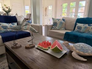 a living room with a table with watermelons on it at Suite Escape Villa in Lowlands