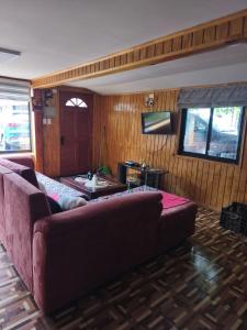 a living room with a couch and a table at Ventisqueros Coyhaique in Coihaique
