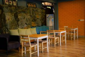 a row of tables and chairs in a restaurant at Sinharaja Kithula Eco Cabanas in Batuwangala +1 photo