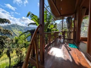 a room with a balcony with a view of the mountains at Ella Antara Green Wood Cottage in Ella