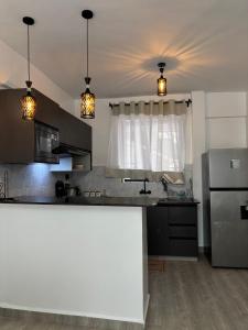 a kitchen with a counter top and a refrigerator at Apartment in Kitusuri in Nairobi