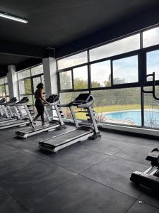 a woman running on a treadmill in a gym at Apartment in Kitusuri in Nairobi