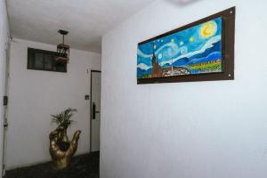 a painting hanging on a wall in a room at Hotel don Bosco in Guadalajara