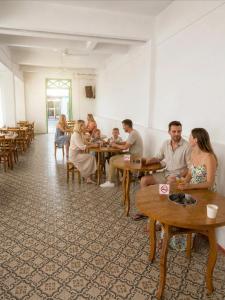 a group of people sitting at tables in a room at Green Group Hotel & Pool Bangkok Old Town in Bangkok