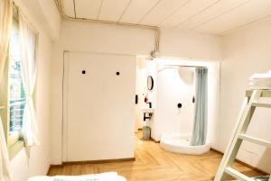 a bathroom with a shower and a white door at Green Group Hotel & Pool Bangkok Old Town in Bangkok +71 photos