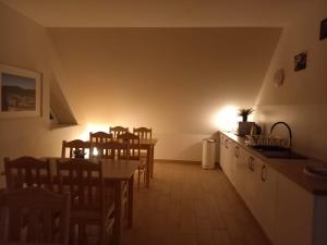 a kitchen and dining room with a table and chairs at Pokoje u Strażaka in Krościenko