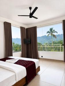 a bedroom with a bed and a large window at River Side Paradise By Greenleaves Munnar in Anachal