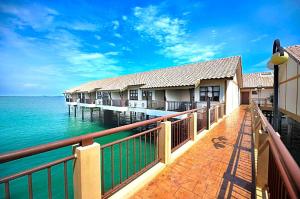 a row of houses on a pier over the water at Brassalova Signature Stay in Port Dickson