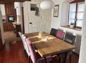 a dining room with a wooden table and chairs at Istrian Private Garden Oasis in Žminj