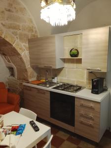 a kitchen with a sink and a stove top oven at Trullo martina in Martina Franca +10 photos
