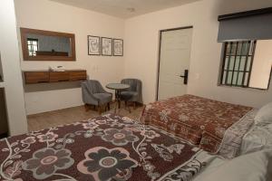 a bedroom with two beds and a table and a desk at Hotel don Bosco in Guadalajara +8 photos