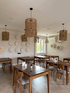 a dining room with wooden tables and chairs at Small Cozy Spa Hotel in Aktobe