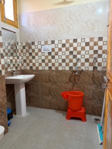 a bathroom with a toilet and a sink at Aangan by Mom in Kalpa +12 photos