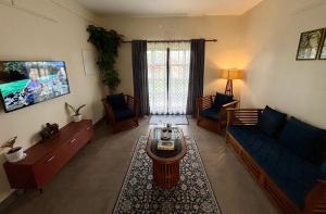 a living room with a couch and a table at Sudama Cityscapes in Cochin