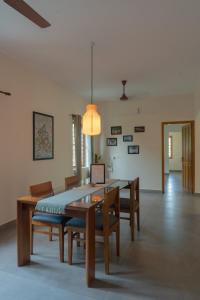 a dining room with a table and chairs at Sudama Cityscapes in Cochin +13 photos