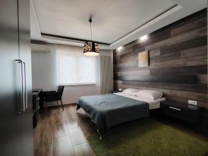 a bedroom with a bed and a desk with a chair at Villa Sarajevo Heights ex Villa Kolonija in Sarajevo +83 photos