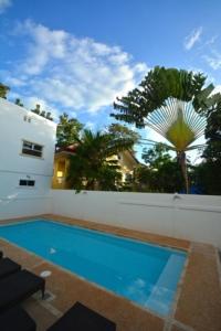 a swimming pool in the backyard of a house at Panglao Regents Park Resort in Panglao Island