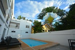 a swimming pool in the backyard of a house at Panglao Regents Park Resort in Panglao Island +59 photos