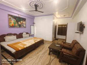 a bedroom with a bed and a couch and a chair at Hill View in Pushkar +52 photos