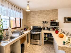 a kitchen with a sink and a stove top oven at Departamento completo para 6 personas a 3 Min del Estadio Azteca-Banorte y muy cerca de la zona de Hospitales in Mexico City
