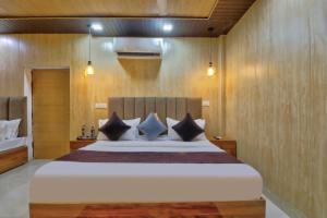 a bedroom with a large bed with wooden walls at Hotel IVY Near Delhi Airport in New Delhi