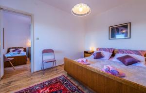 a bedroom with a large bed and a chair at Villa Maria in Krnica +25 photos