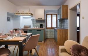 a kitchen and dining room with a table and chairs at Villa Maria in Krnica