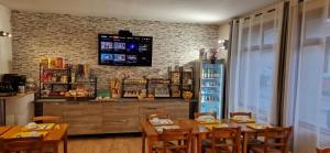 a dining room with a table and chairs and a bar at Le Faubourg in Figeac +56 photos