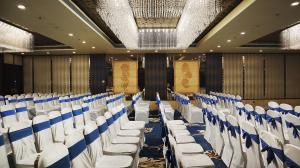 a conference room with white and blue chairs at Hotel Grand Maple in Jaipur