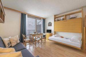 a living room with a bed and a dining room at Studio Sansi 34 - Happy Rentals in Cesana Torinese